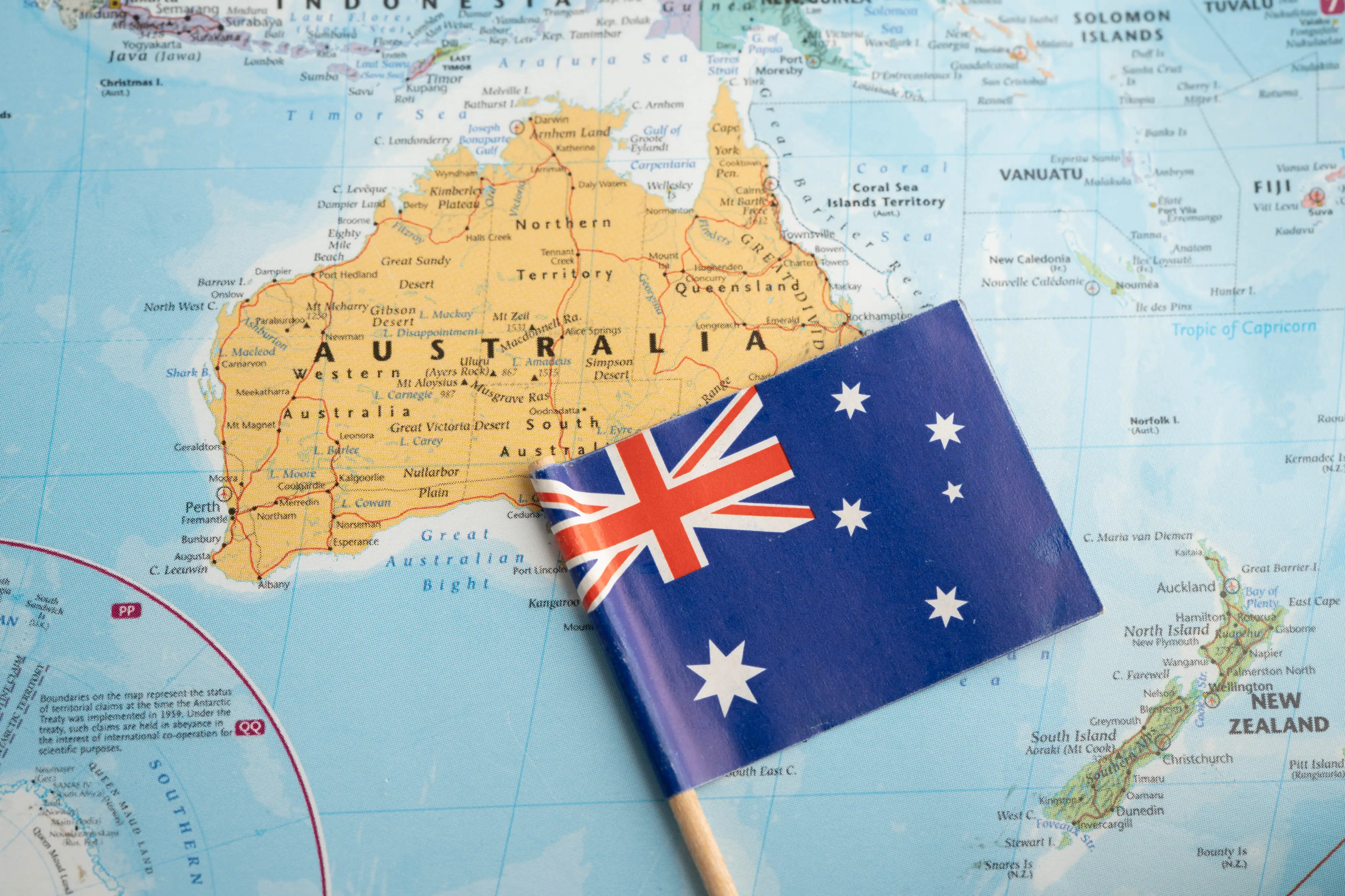 Australian flag resting on a map of Australia