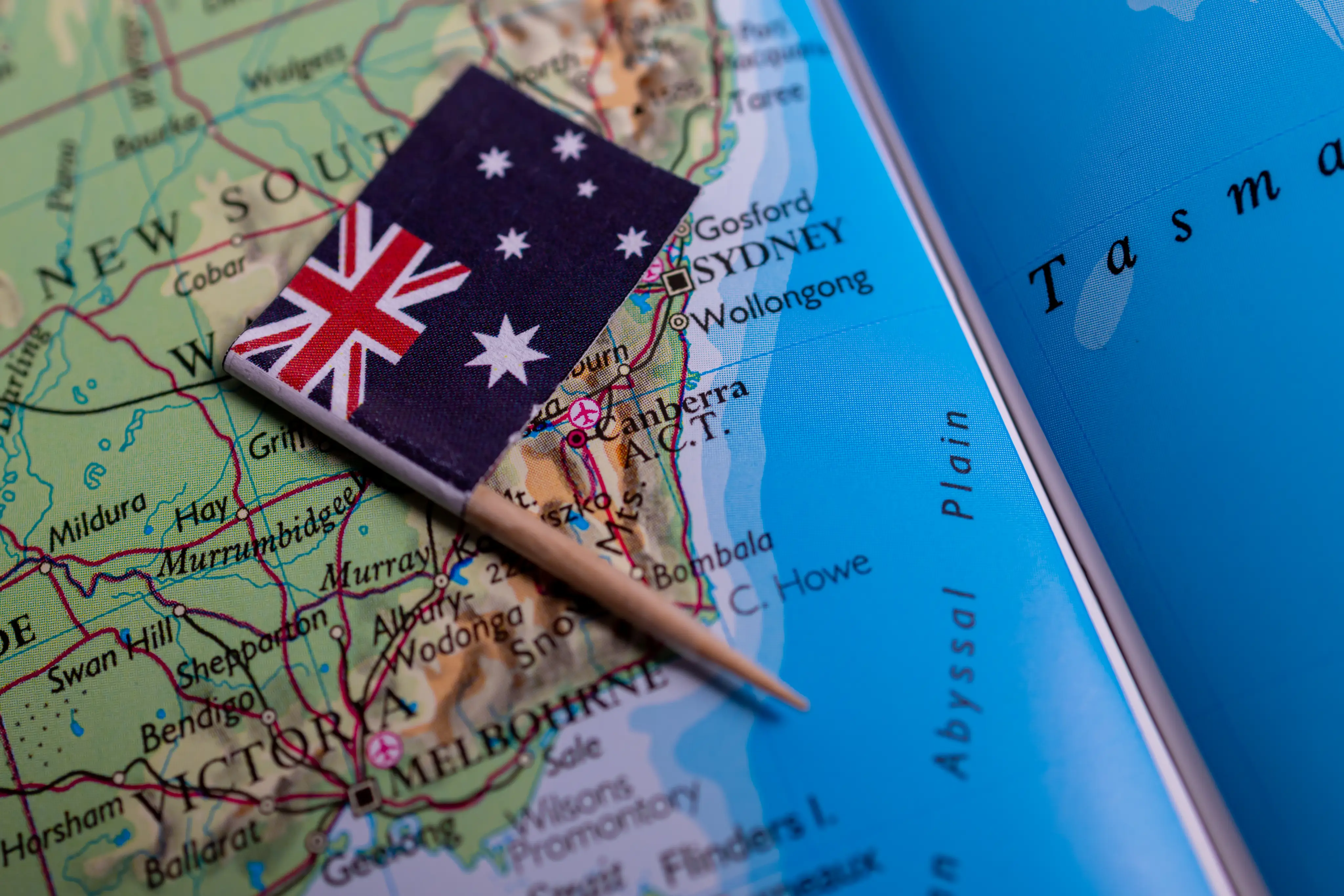 Australian flag marker and travel document over a map of Australia